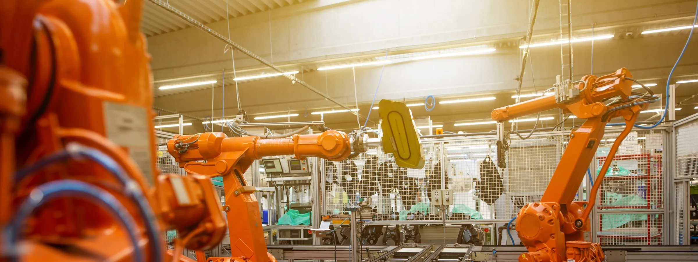 Industrial robot arms on a factory production line.