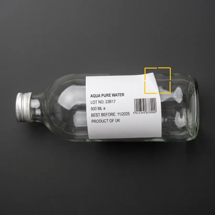 Label crooked, edge lifted. Label presence, position and content.